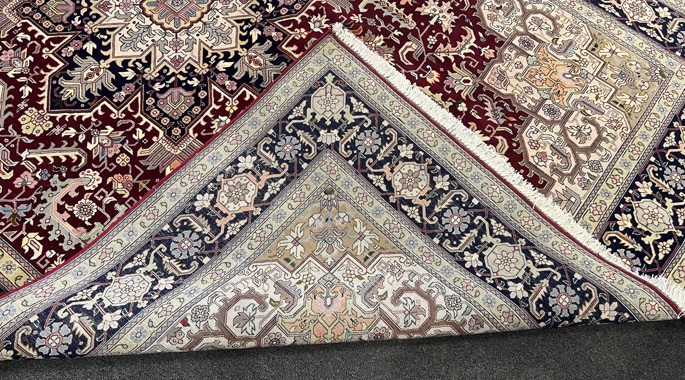 A Tabriz part silk burgundy ground carpet